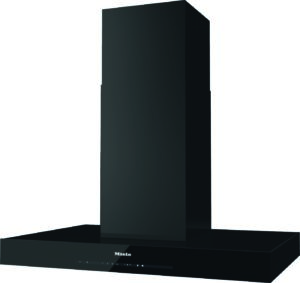 Black chimney-style kitchen range hood over a cooktop, with a glossy front panel and the Miele logo on the lower front edge.