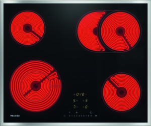 Electric glass-ceramic cooktop with four glowing red coil burners and a central digital control panel (Miele)