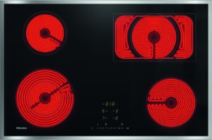 Black glass electric cooktop with four red-hot radiant coil burners and a central digital control panel; Miele branding visible on left.