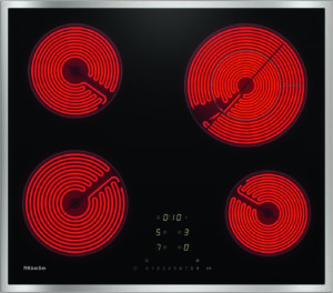 Black glass-ceramic cooktop with four glowing red electric coil burners and a central control panel