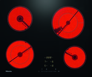 Electric four-burner induction-looking stove with red-hot coil elements and a central digital control panel (Miele).