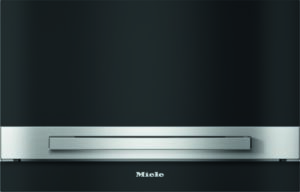 Front view of a Miele appliance with a brushed steel horizontal handle on a dark panel, logo visible below.