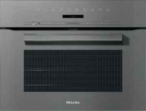 Front view of a stainless steel Miele oven with a slim control panel and handle, gray textured surface, and a large vent section below.
