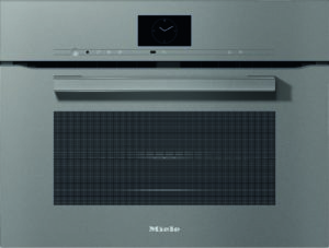 Front view of a Miele built-in oven with a small square clock display above a slim control bar and a long horizontal handle, metal-grey finish.