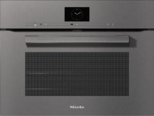 Miele built-in oven front with a digital clock, slim control bar, and large vent grill below.