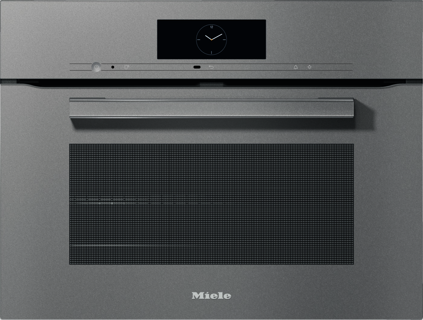 Front view of a Miele built‑in oven with a circular clock display, control strip, and long handle on a metallic door (kitchen appliance).