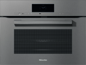 Front view of a Miele built-in oven with a digital clock display and metal handle on a gray stainless finish.