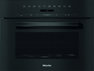 Front view of a Miele built-in oven with a dark finish, a horizontal handle, a digital clock display, and icons along the top panel indicating controls and settings.