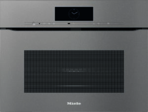 Miele built-in oven front with a clock display, control bar, and large vent below on a stainless panel.