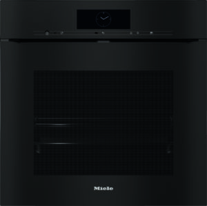 Black Miele oven/steam oven built into a cabinet, featuring a digital clock display on the control panel and a large vented front panel; brand name visible at the bottom.