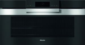 Built-in Miele oven with a black front, stainless steel handle, and a centered clock display.