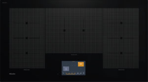Induction cooktop with four zones and a central control panel; orange 200° indicator on the right zone; 'TempControl' labels under side zones; Miele branding in bottom-left corner.