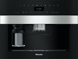 Front view of a black Miele espresso machine with a silver portafilter and glass carafe on the left under a stainless-steel bar and digital clock display showing 12:00.