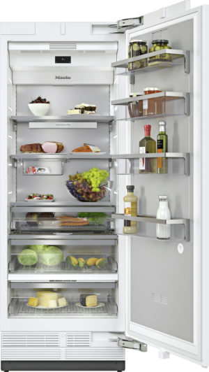 Open stainless fridge with food organized on multiple shelves: fruit, cheese, bread, vegetables, and condiments on the door.