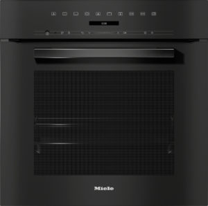 Miele built-in oven front with digital time display reading 12:00, row of control icons, sleek black panel.