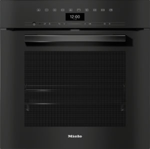 Front view of a black Miele built-in dishwasher with a top control panel and digital clock showing 12:00.