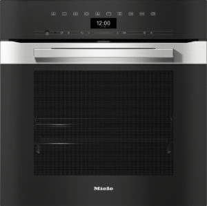 Black built-in kitchen oven with a stainless steel handle and touch-sensitive control panel; digital display shows 12:00, '31. Mai'