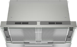 Top view of a stainless steel range hood with glass sides, mesh filters, and a center control panel for ventilation.