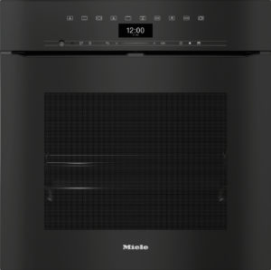 Built-in Miele dishwasher front with top control panel, digital clock reading 12:00, and textured lower door panel.