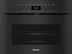 Top control panel of a Miele wall oven with a digital clock showing 12:00 and a row of icons; dark finish.