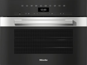 Built-in Miele oven with a stainless steel handle and black control panel showing the time 12:00 on a digital display.