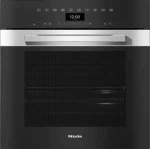 Built-in Miele oven with a black control panel and stainless handle, centered display and vent area above the door