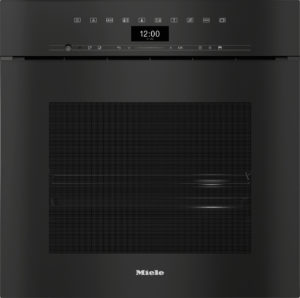 Front view of a black Miele built-in dishwasher with a top control panel and digital clock reading 12:00.