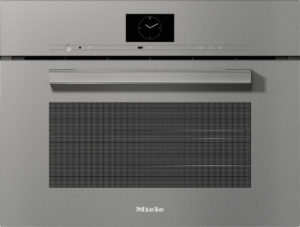 Front view of a grey Miele built‑in oven with a digital clock on the control panel and a long horizontal handle above a vented opening