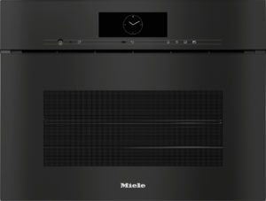 Front view of a black Miele built-in wall oven with a central circular clock display and a slim control panel above the door edge.