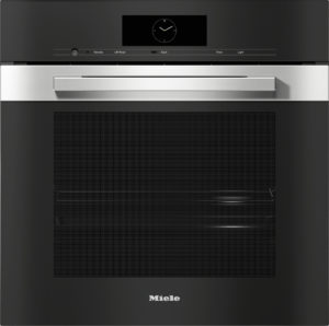 Built-in black oven with a stainless steel handle and a digital/analog clock display on the control panel above the grille area, brand Miele visible at the bottom.