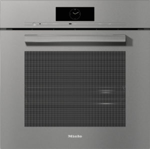 Built-in Miele oven with a clock display, horizontal control panel, and long metal handle on a metallic kitchen front.