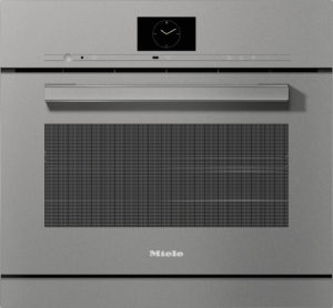Front view of a silver Miele oven with a large horizontal handle, control panel along the top, and a circular clock display on the door
