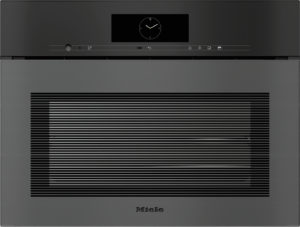 Built-in Miele oven front with circular clock display above and a glass door featuring horizontal stripes across the window.