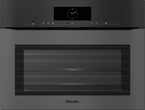 Built-in Miele oven with a central clock on the control panel above a large vented door panel.