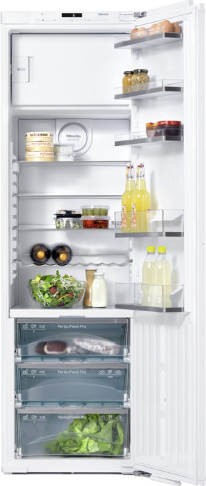 Open refrigerator with eggs, cheeses, jars, beverages, and a salad on clear shelves and drawers inside.