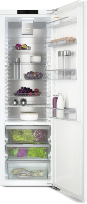 Open refrigerator showing shelves with fruits, vegetables, eggs, dairy, and bottles; bottom drawers store greens and roots.