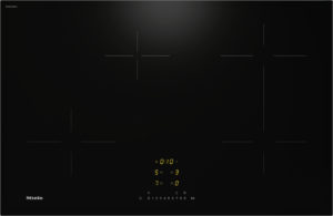 Black induction cooktop with four cooking zones and faint cross markers; center-bottom yellow digital display and touch controls; Miele logo in lower-left corner.