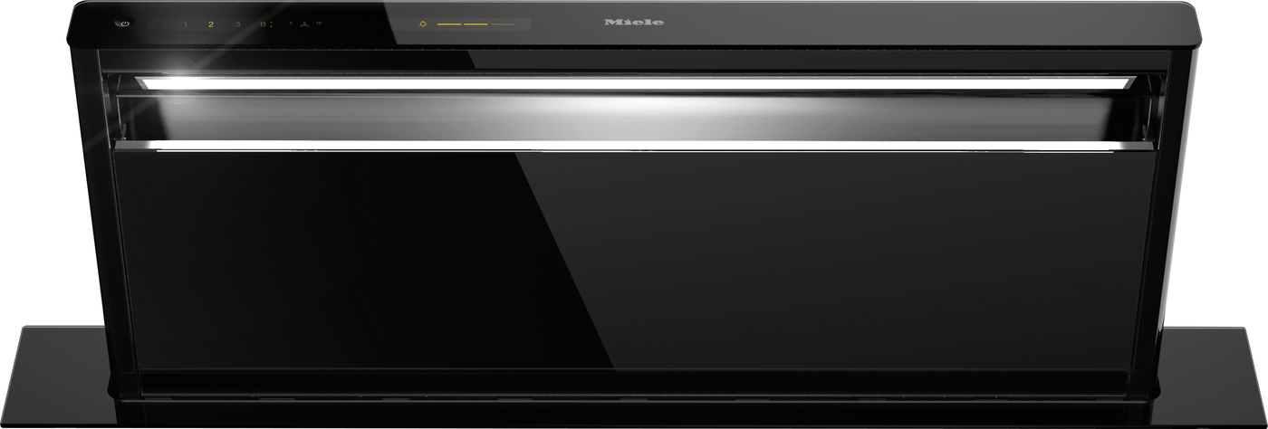 Sleek black Miele wall-mounted range hood with a glossy finish, touch controls on the top edge and built-in LED light.