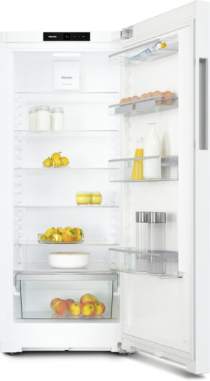 Open white refrigerator showing shelves with eggs, milk bottles, juice, and fruit including apples and oranges, plus a bottom fruit drawer