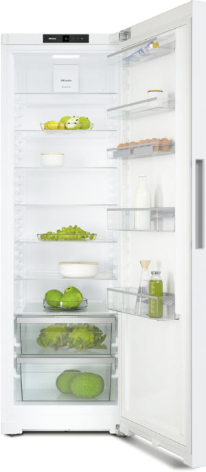 Open white refrigerator with multiple shelves displaying eggs, milk, fruits, vegetables, and beverages; brand label Miele visible at top.