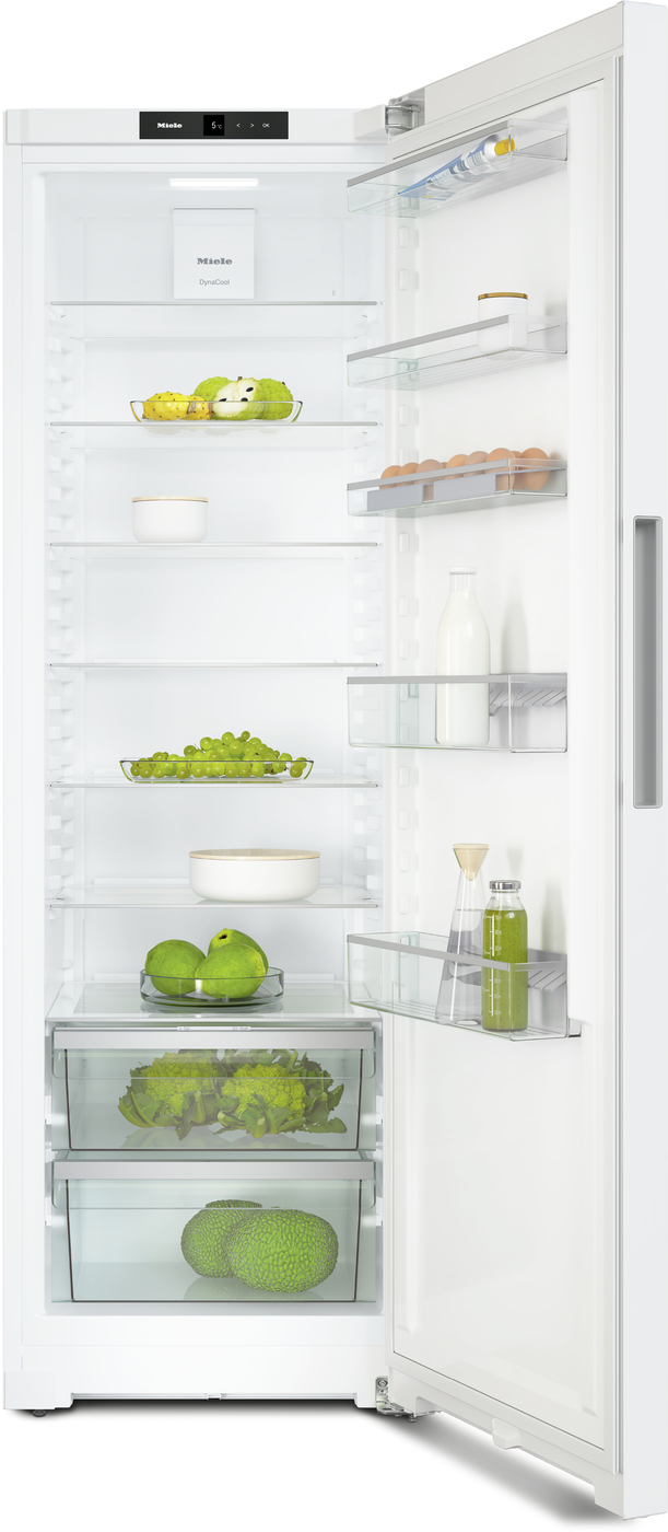 Open white refrigerator with multiple shelves displaying eggs, milk, fruits, vegetables, and beverages; brand label Miele visible at top.