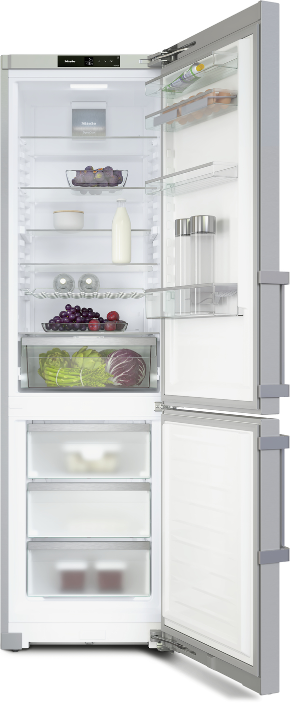 Open tall refrigerator with dairy, produce, and beverages on shelves and in crisper drawers; fruits and vegetables visible inside.