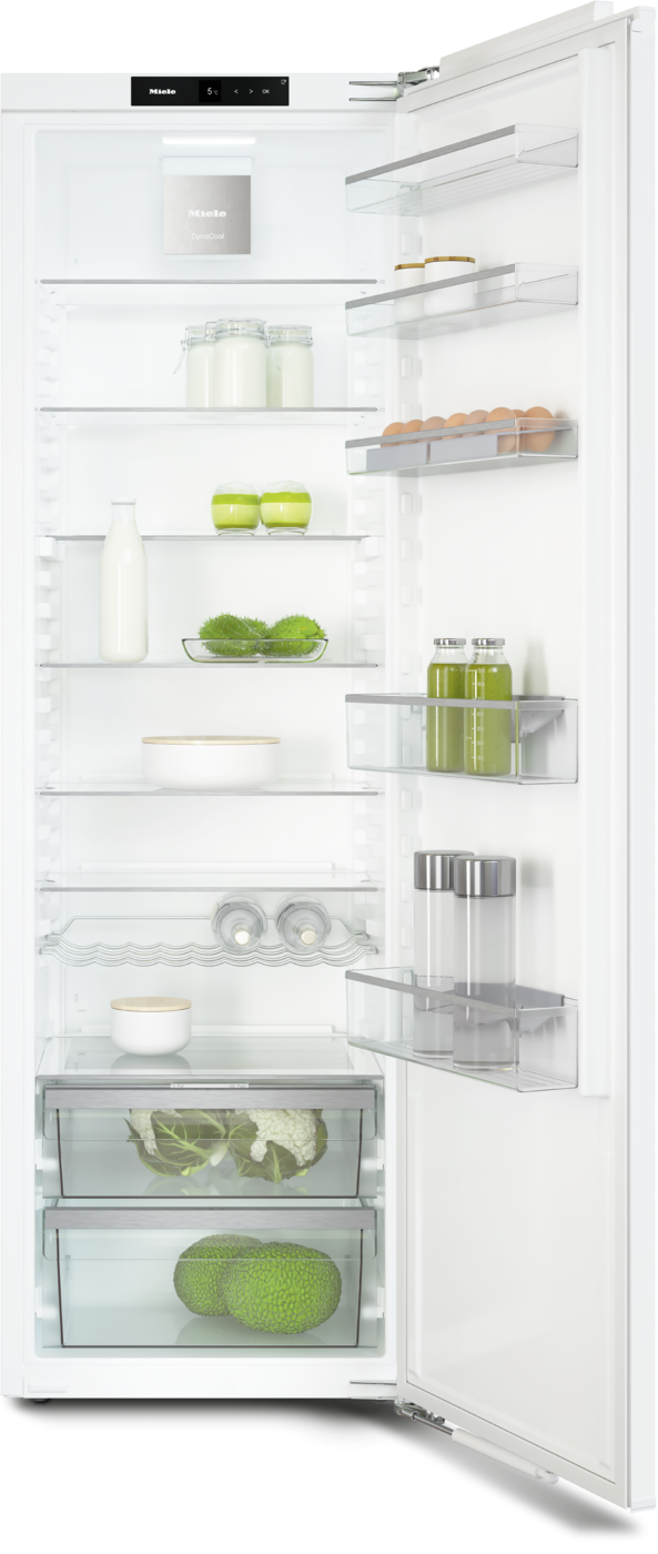 Open refrigerator showing shelves with milk, jars, eggs, vegetables, and condiments, ready for use.