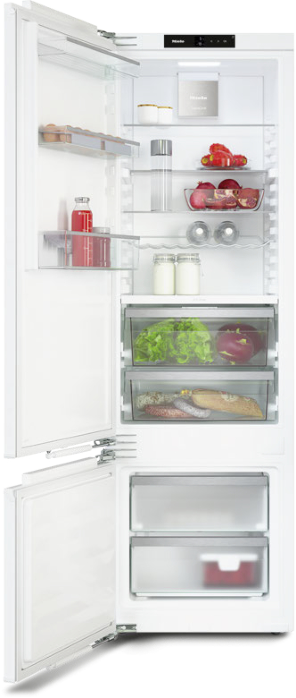 Open refrigerator with shelves of milk, juice, produce, and bread; freezer drawers at bottom.
