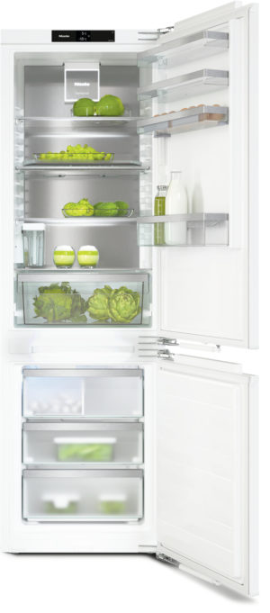 White 2-door refrigerator with the doors open, showing organized shelves of vegetables, milk, and eggs inside and in the freezer drawers below