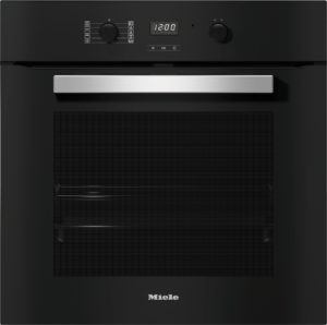 Built-in black oven front with a wide brushed metal handle and digital controls (Miele).