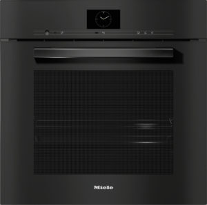 Black built-in oven with a centered clock display, slim control bar, and long metallic handle on a dark front (Miele logo below).