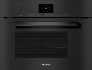 Black Miele built-in oven front with a long horizontal handle and a centered analog clock display above the control strip.