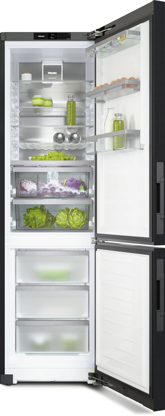 Open modern refrigerator interior with multiple glass shelves and door racks, stocked with vegetables, drinks, and eggs, plus bottom freezer drawers.