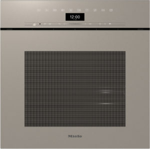 Front view of a beige Miele built-in oven with a digital clock showing 12:00, control icons along the top, and a large ventilation grille in the center.